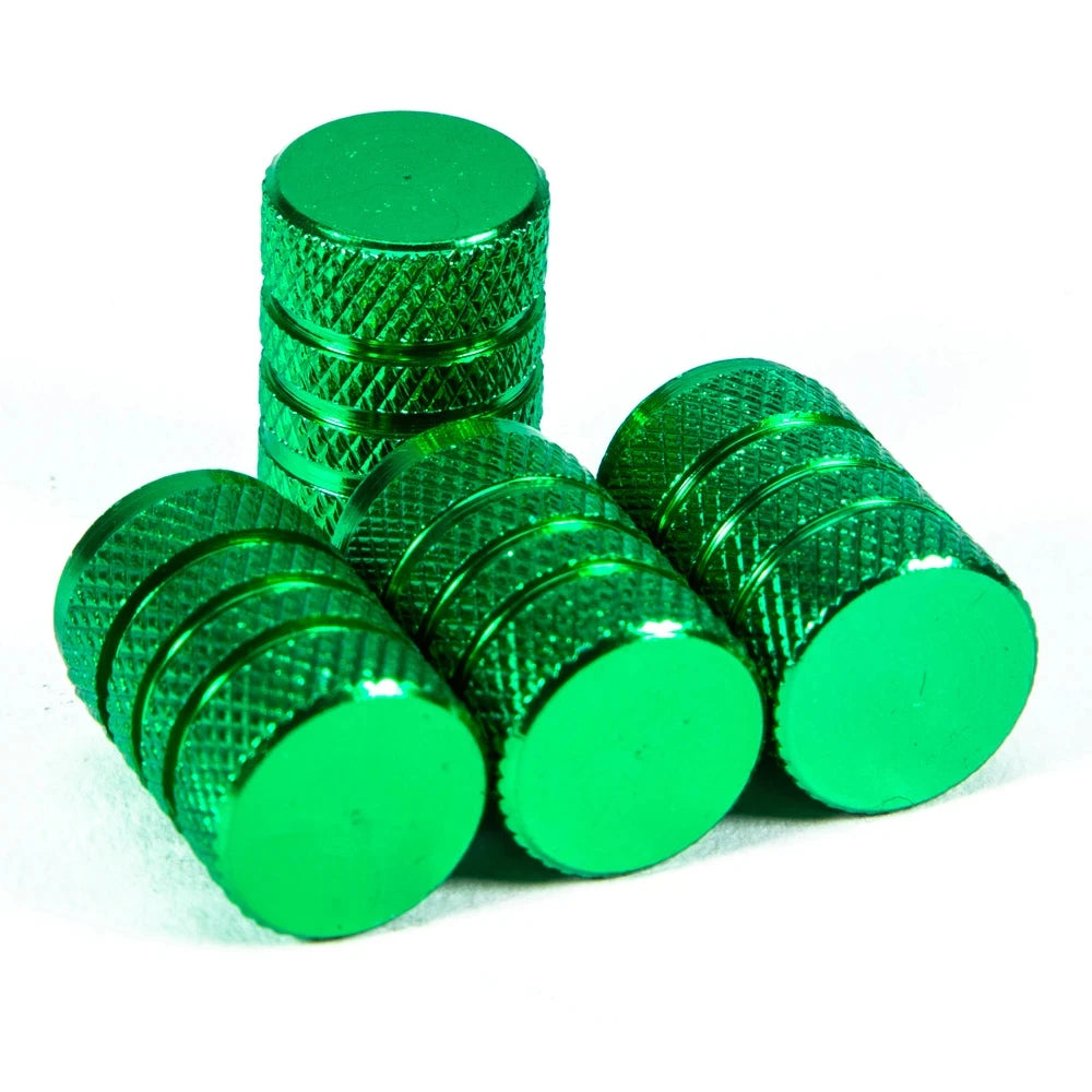 A set of bright green aluminum tire valve caps, cylindrical and textured.