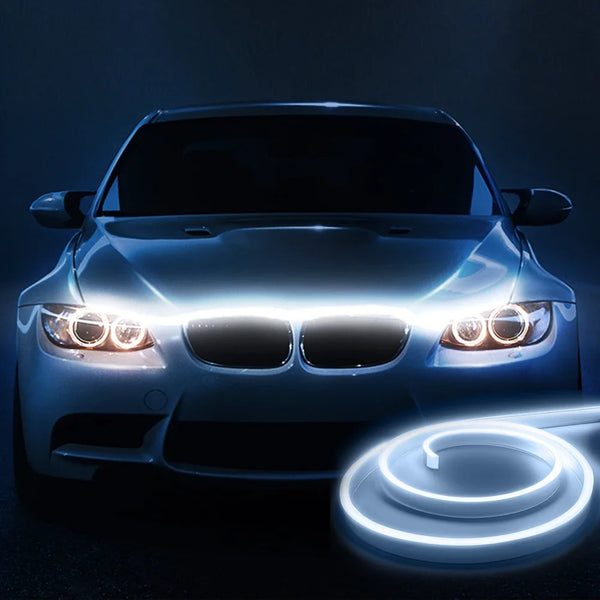 Front view of a car with bright LED light strips installed on the hood and headlights.