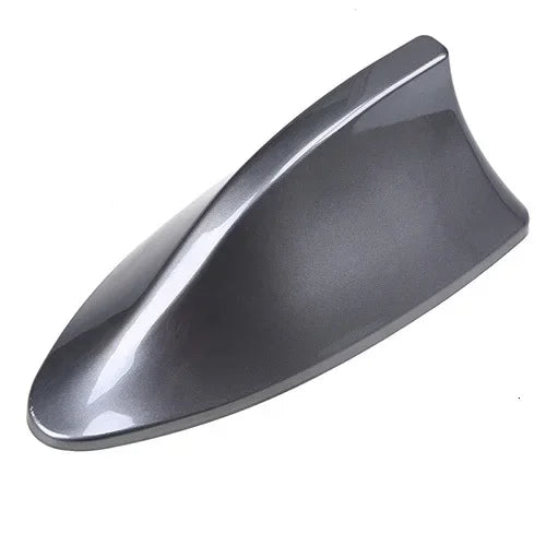 A sleek, gray shark fin decorative car antenna cover viewed from above.