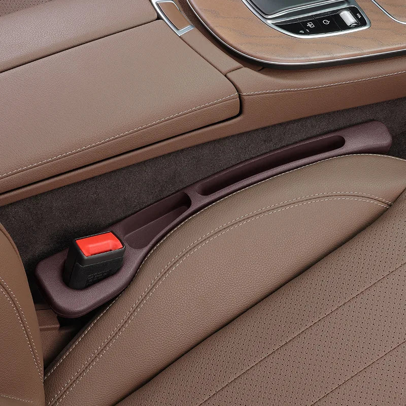 A brown car seat gap plug and storage organizer is shown in a vehicle interior setting.