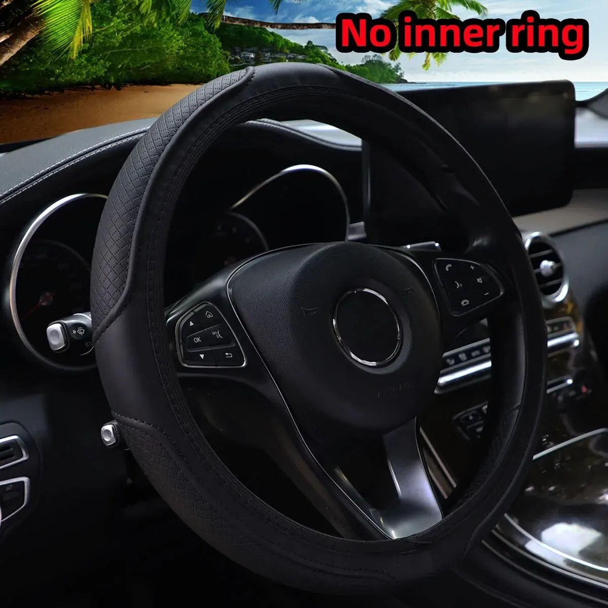 Black embossed leather steering wheel cover inside a car with a tropical view outside