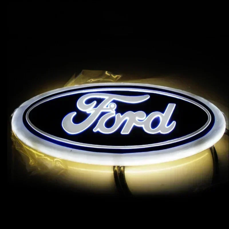 A glowing blue LED logo emblem for a Ford vehicle, displayed against a dark background.