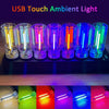 A row of ten USB touch ambient light bulbs glowing in various colors on a black surface.