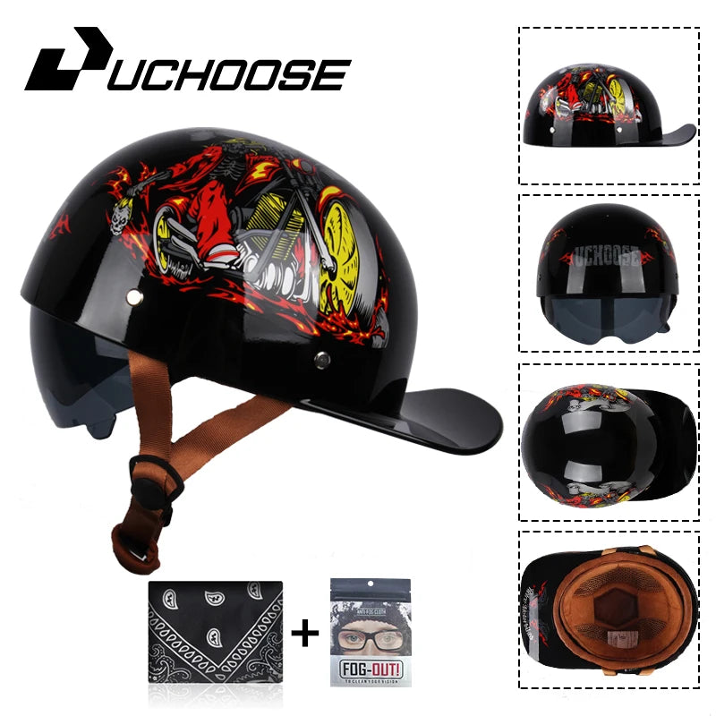 A black motorcycle helmet with a fiery graphic and a leather visor, shown next to accessories.