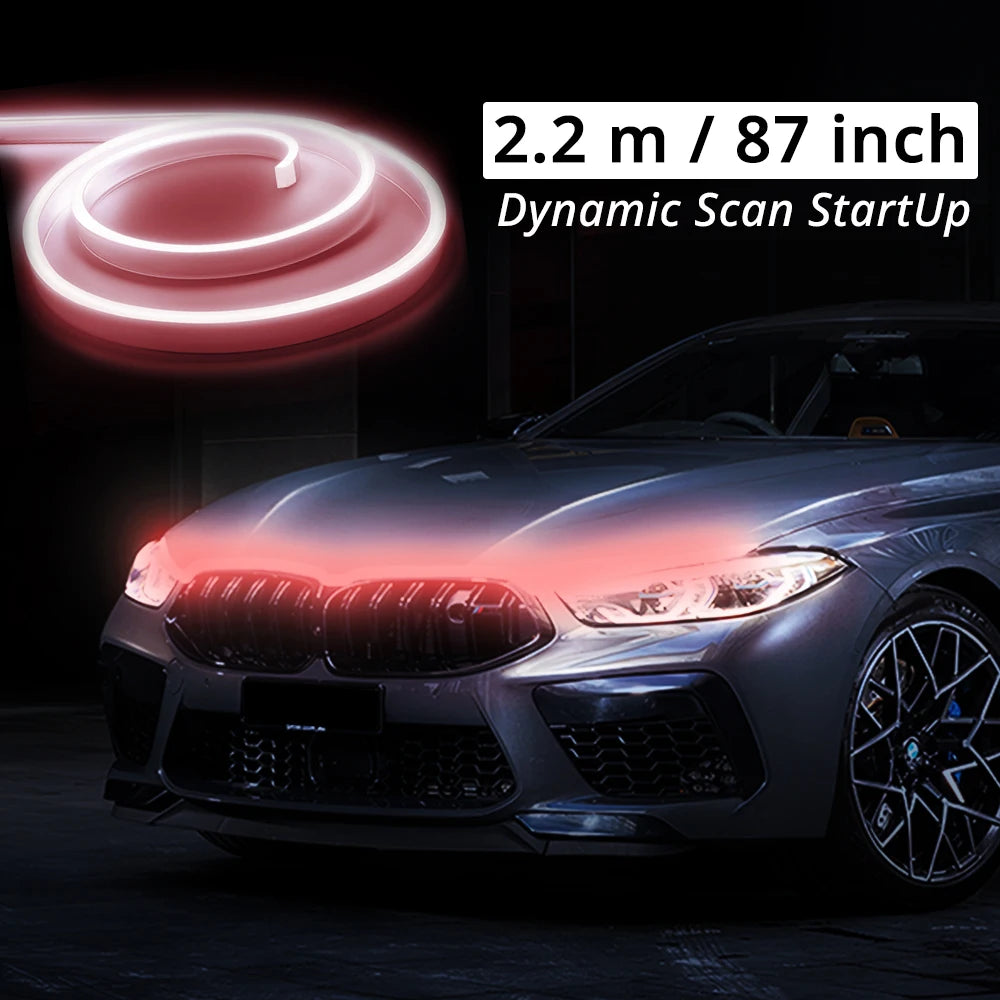 A close-up of a car's front grille and hood showing a bright red LED light strip effect.