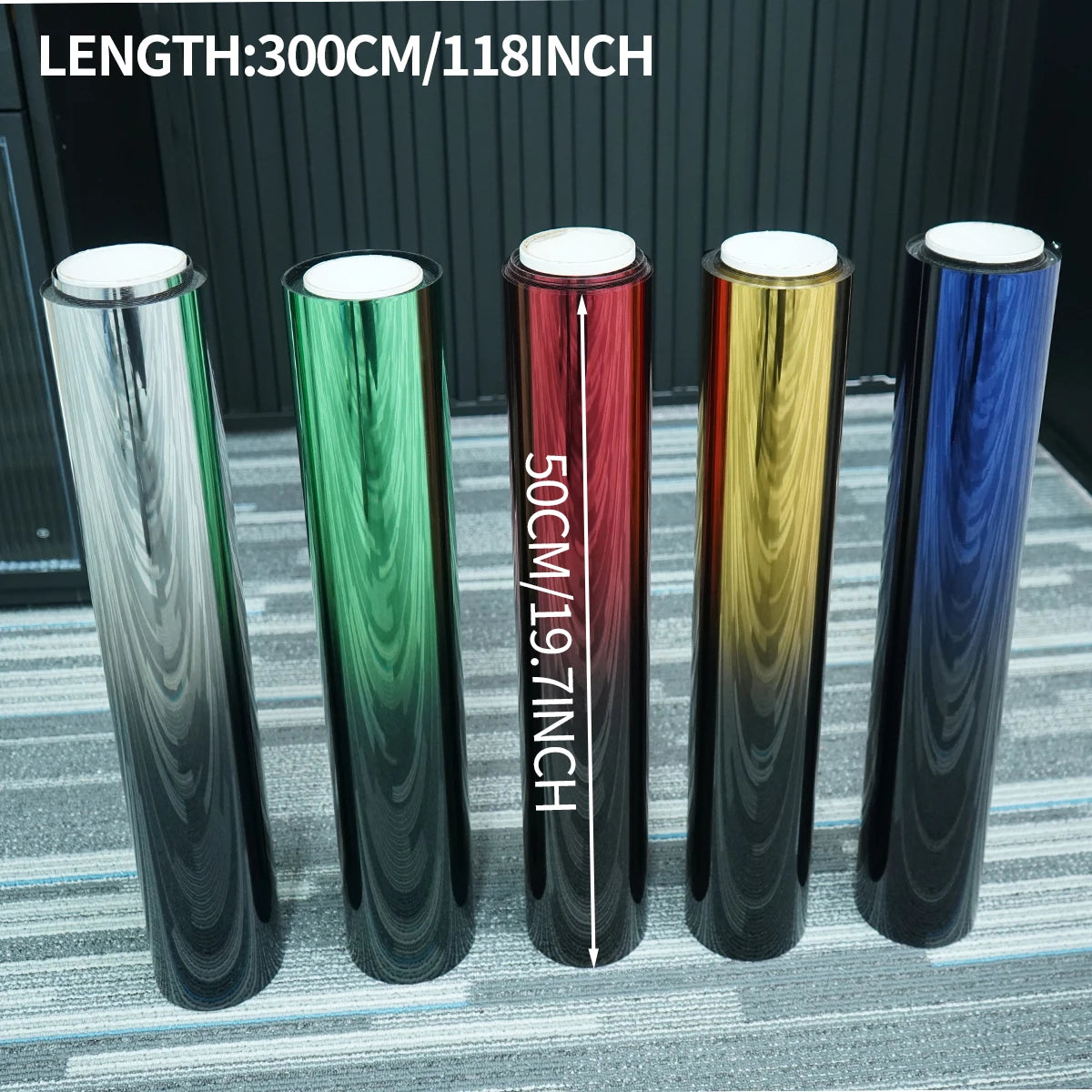 A row of five long, cylindrical color-changing window tint films displayed against a gray background.