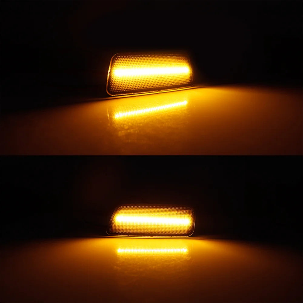 A close-up of an LED side marker turn signal illuminating a reflective surface.