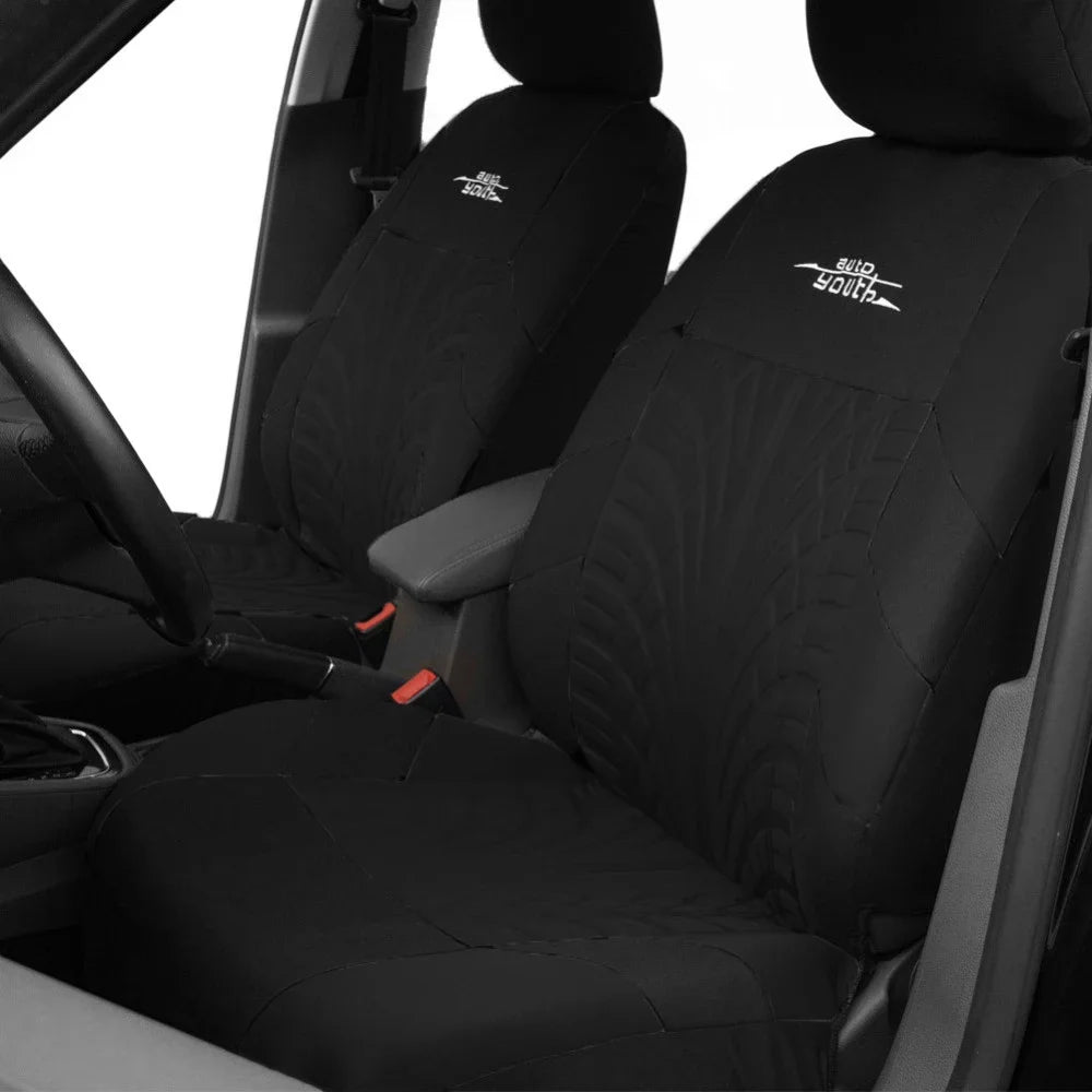 Black universal car seat protector covers installed on a vehicle seat.