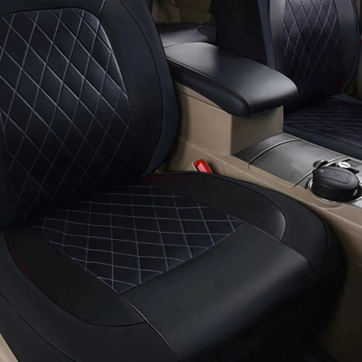 Close-up view of black quilted PU leather car seat covers installed in a vehicle interior.