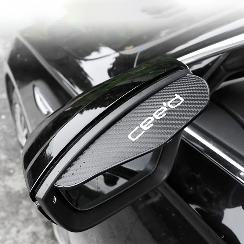 Black carbon fiber rain shield for a car rearview mirror.