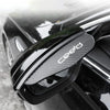 Black carbon fiber rain shield for a car rearview mirror.