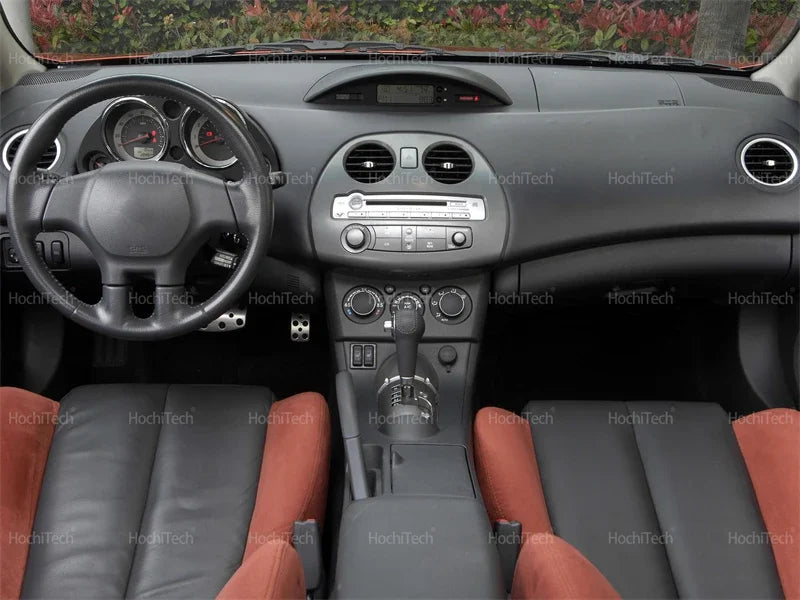 Interior view of a car dashboard and steering wheel with leather seats.