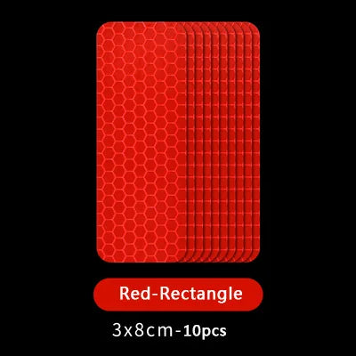 Une pile de rectangles rouges, utilisés comme autocollants de sécurité réfléchissants pour portes universels.