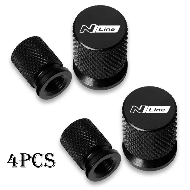 Set of four black N Line tire valve caps for car wheels