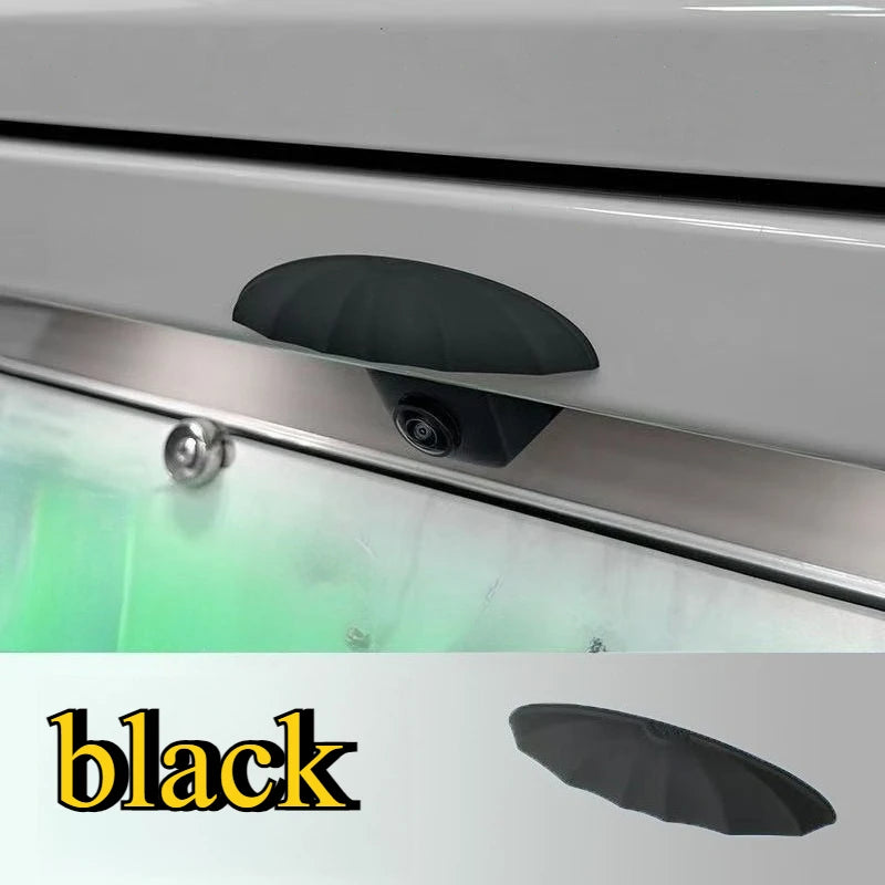 A black universal car rain shield and rear camera cover is shown mounted on a vehicle's exterior.