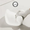 A hand is gently pressing a white memory foam pillow against a white surface, demonstrating soft rebound.