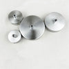 Three round modern stainless steel pendant lamp diffusers arranged horizontally.