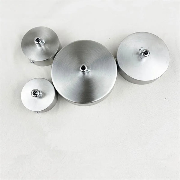 Three round modern stainless steel pendant lamp diffusers arranged horizontally.
