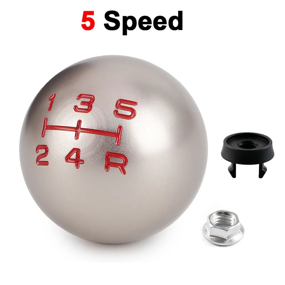 A silver aluminum ball shift knob with numbered and lettered markings, along with mounting hardware.