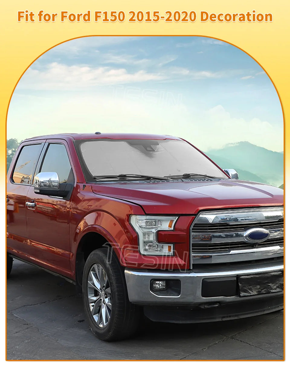 Aluminum foil windshield sunshade for a red Ford F150 truck.