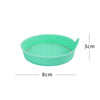 A light green silicone cup holder coaster with a textured surface and a small lip.