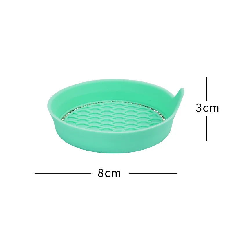 A light green silicone cup holder coaster with a textured surface and a small lip.