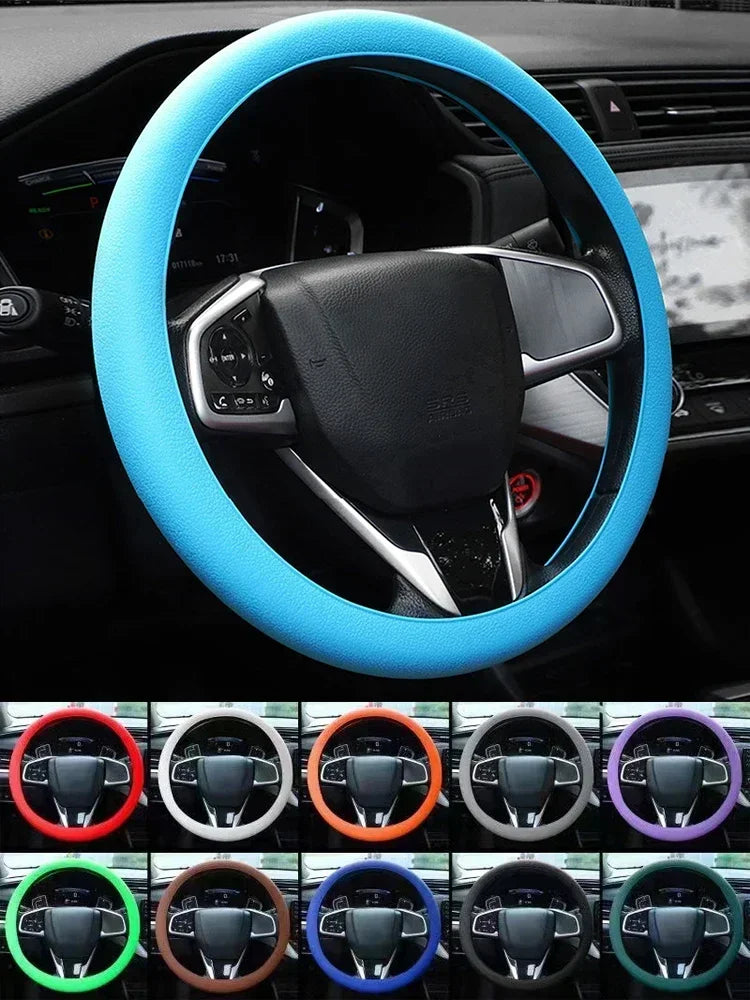 A close-up view of a blue silicone steering wheel cover installed on a car's steering wheel.