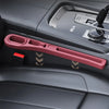 A pink car seat gap filler organizer is shown in a dark gray car interior console.