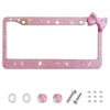 Pink glitter license plate frame with a bow accent and small mounting hardware.