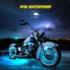 A motorcycle is shown under heavy rain with bright blue LED lights illuminating the scene.