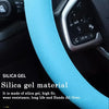 Close-up of a light blue silica gel material steering wheel cover on a car interior.