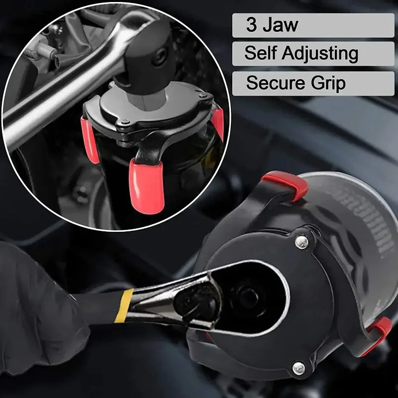 Close-up of a black oil filter removal tool with a self-adjusting jaw and secure grip, shown being used on an engine componen