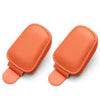 A pair of orange magnetic leather sunglasses holders designed for car sun visors.