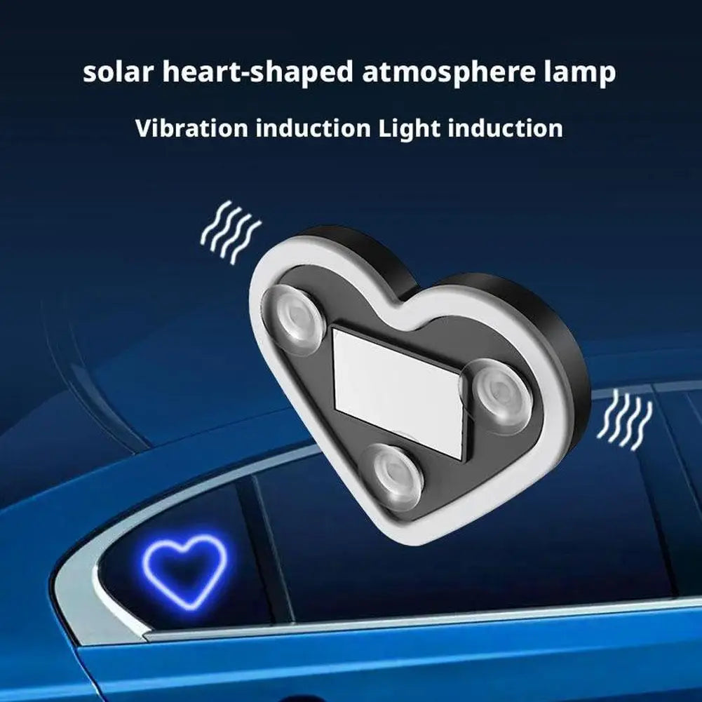 A heart-shaped solar lamp is shown illuminating a car window with a bright blue light.