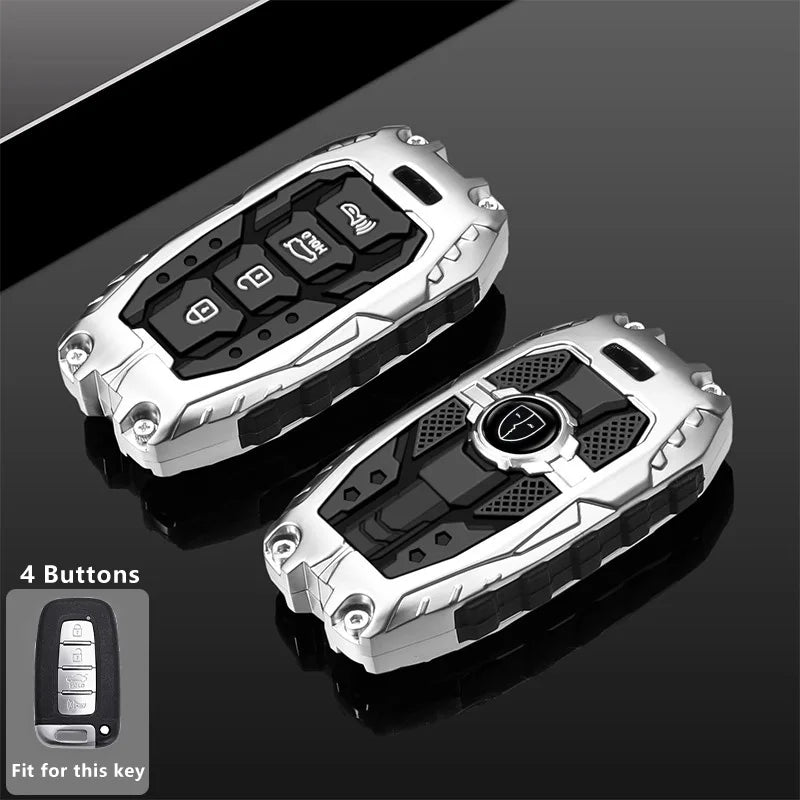 Silver key fob cover with four buttons shown on a dark surface.
