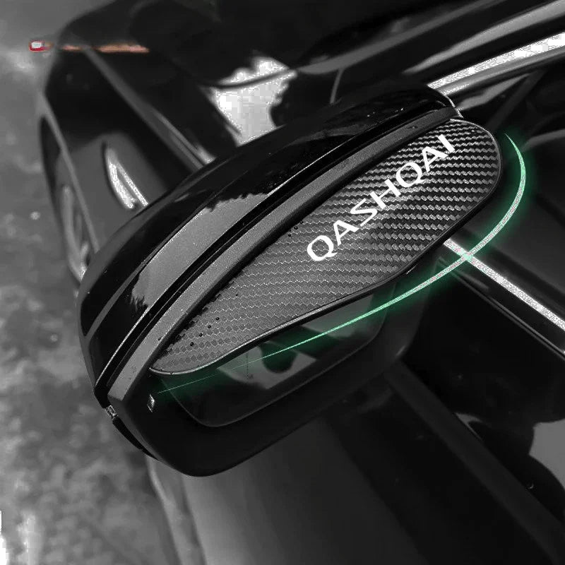 Close-up of carbon fiber rain guards installed on the side mirrors of a black Nissan Qashqai.