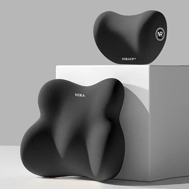 A black ergonomic memory foam pillow, the NIRA model, is displayed on a white box.