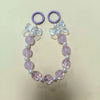 Purple lanyard with a white flower charm and round pink beads for phone anti-loss