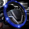 A close-up of a car steering wheel covered in sparkling blue LED rhinestones.
