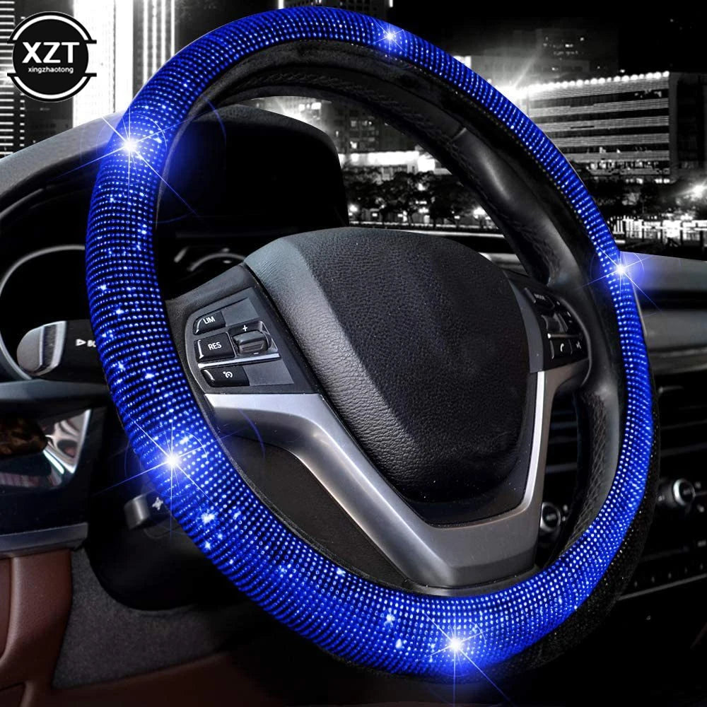 A close-up of a car steering wheel covered in sparkling blue LED rhinestones.