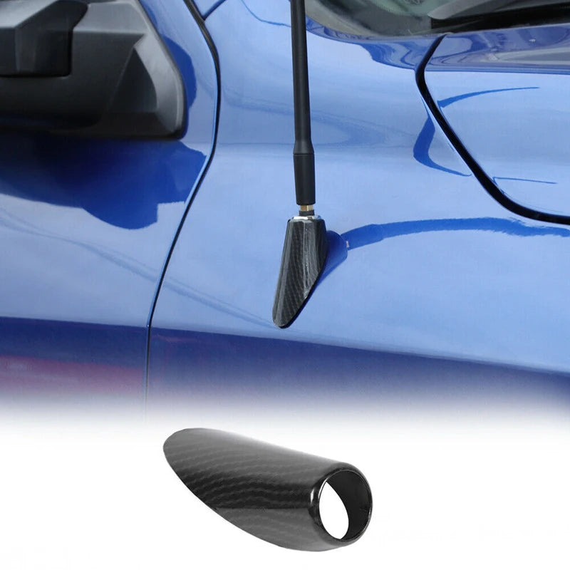 Close-up of a black carbon fiber look antenna base trim installed on a blue Dodge RAM vehicle.