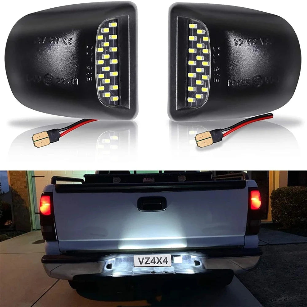A pair of high brightness 18 LED license plate lights for trucks shown alongside an installed light on a silver pickup truck.