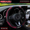 A maroon carbon fiber steering wheel cover for a car, shown inside the vehicle cockpit.