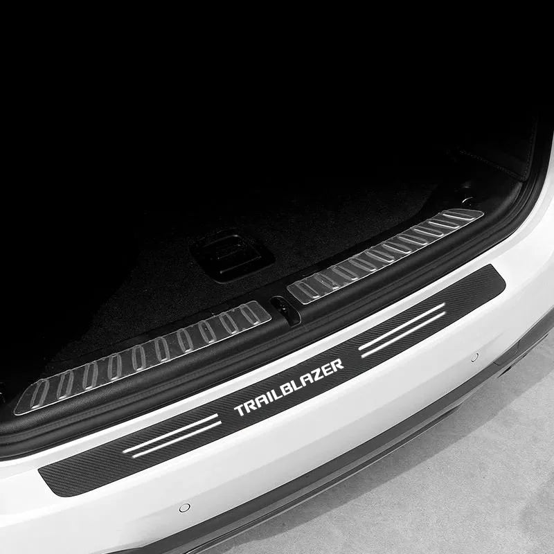 Close-up of a white car door featuring a black carbon fiber decal and the Trailblazer branding.