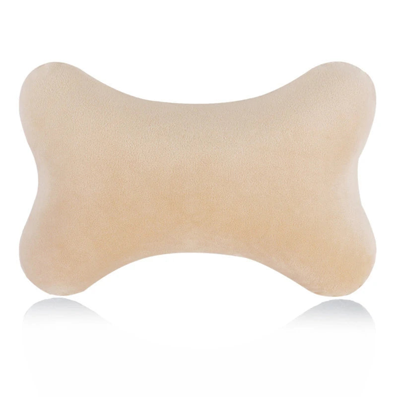 A beige memory foam car neck pillow shown from the side.