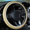 A beige anti-slip leather steering wheel cover is shown inside a car's interior.