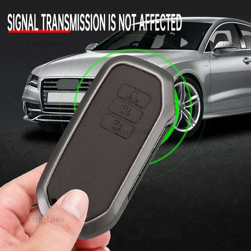 A hand holds a black key fob cover designed to protect and allow signal transmission for Kia vehicles.