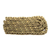 A close-up view of a heavy-duty brass motorcycle chain with multiple sized links.