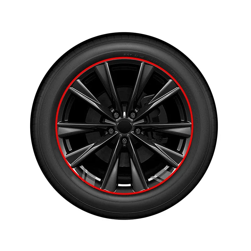 A close-up view of a black car rim with a red protector strip applied to the edge.