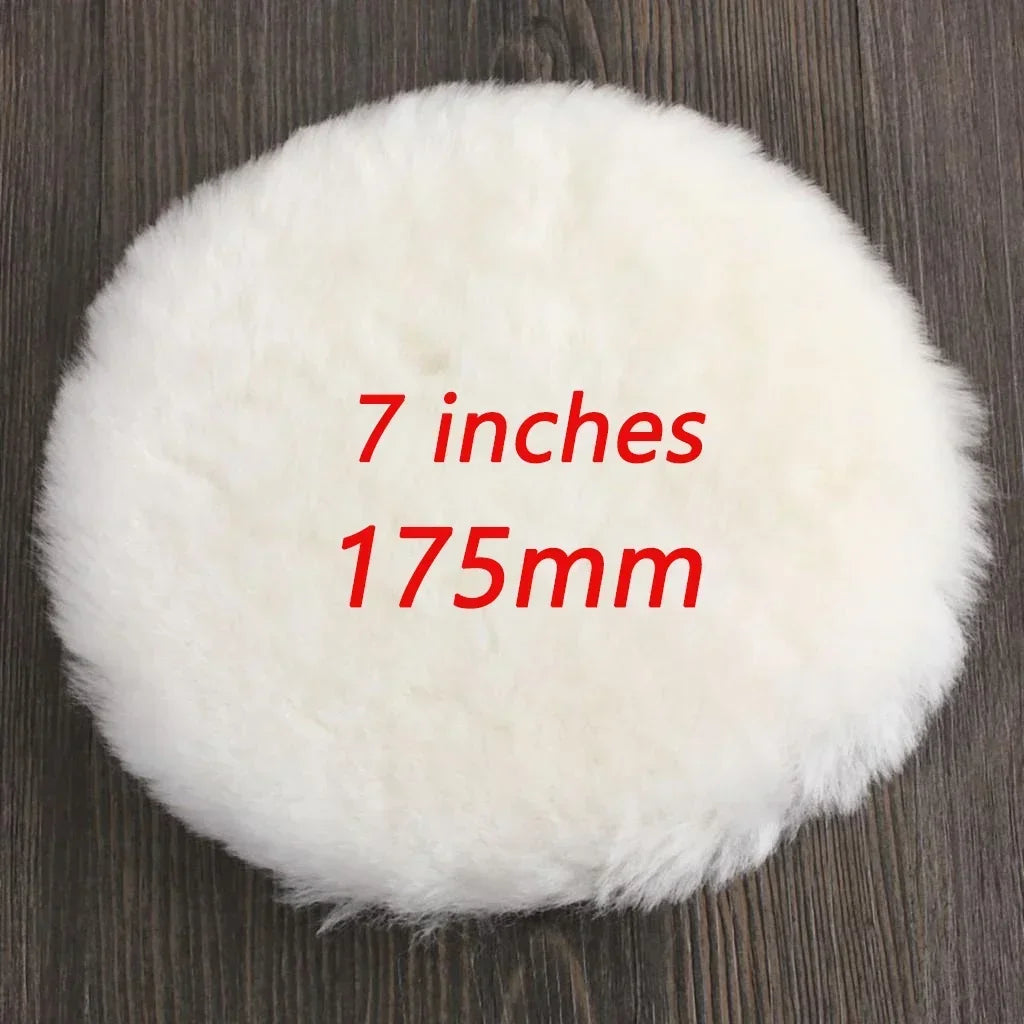 A white, fluffy polishing disc measuring 7 inches or 175mm, resting on a dark wooden surface.